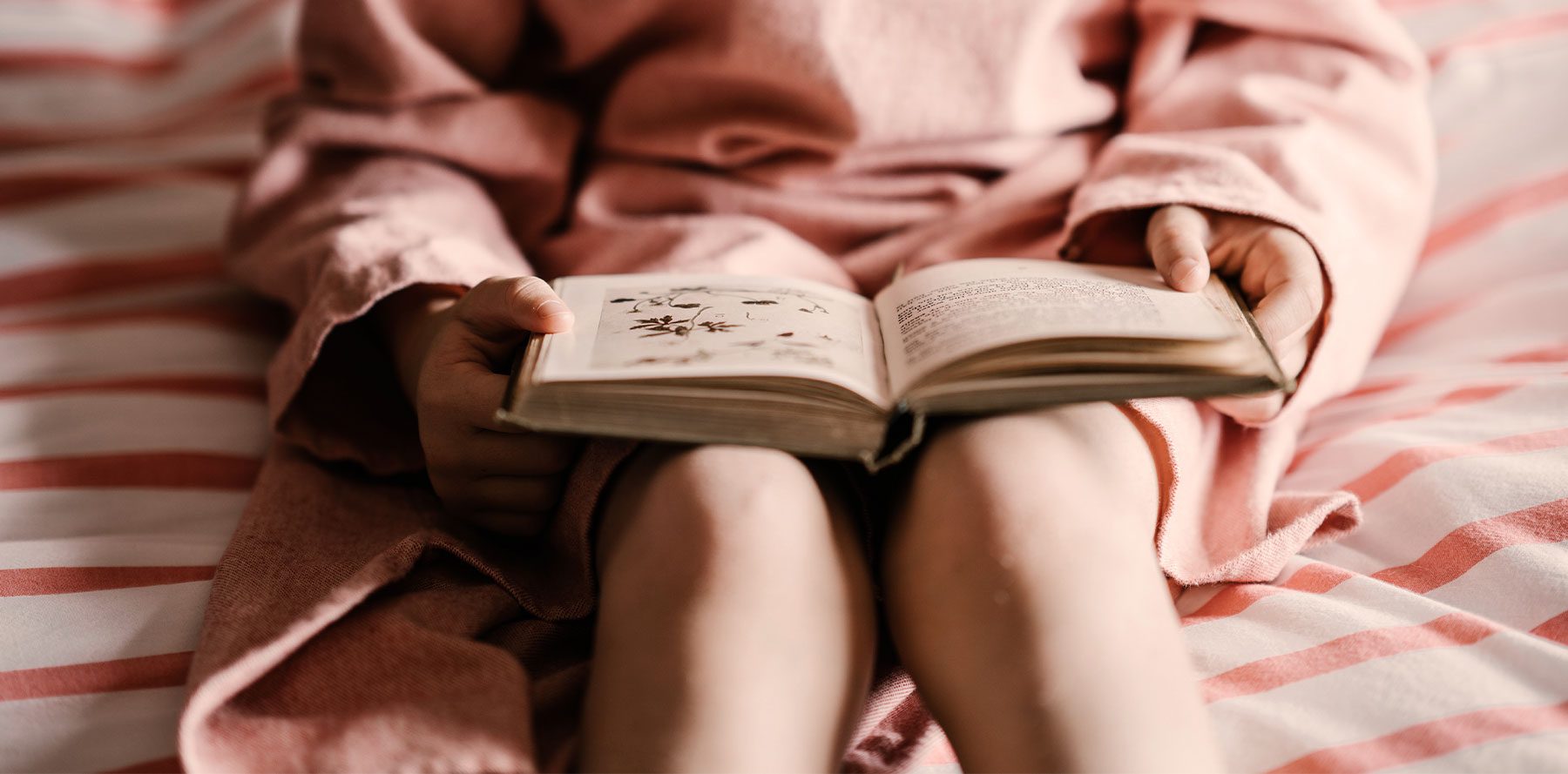 Little Girl Reading with Book on Her Lap