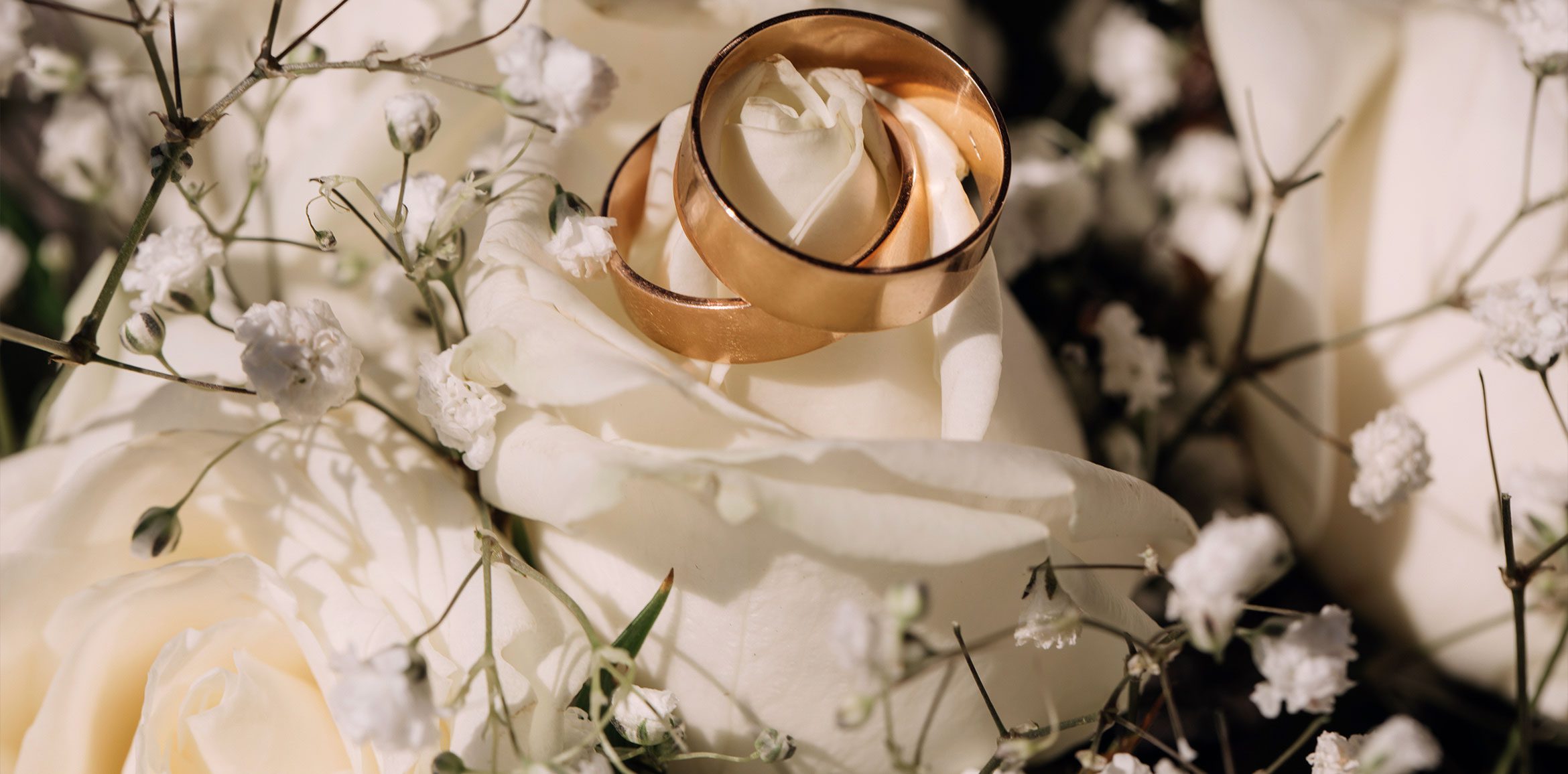 Two Wedding Rings on Fabric and Flowers